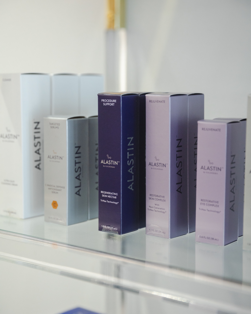 Alastin Skincare products displayed on a shelf, featuring medical-grade skincare designed to support collagen production, skin health, and facial rejuvenation after rapid weight loss.
