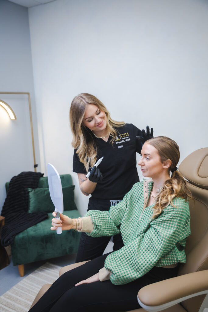 Skin consultation at Pine & River Aesthetics in Little Rock, AR, featuring a provider discussing personalized skin longevity and anti-aging treatment options with a patient.