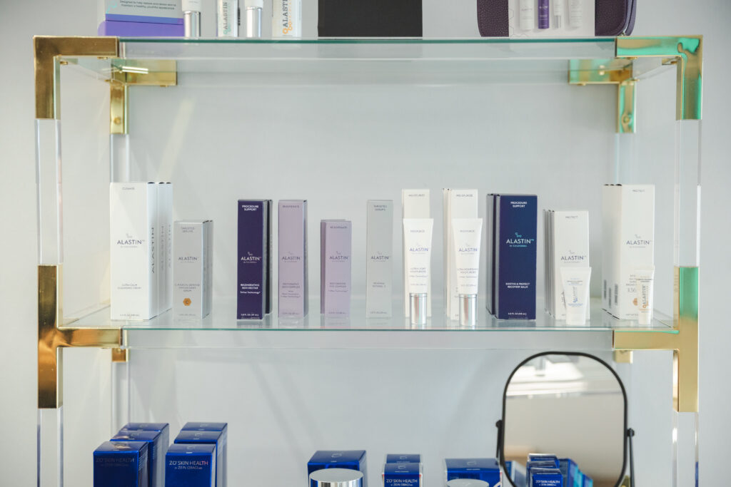 Premium medical-grade skincare products displayed on glass shelves at Pine & River Aesthetics in Little Rock, Arkansas.